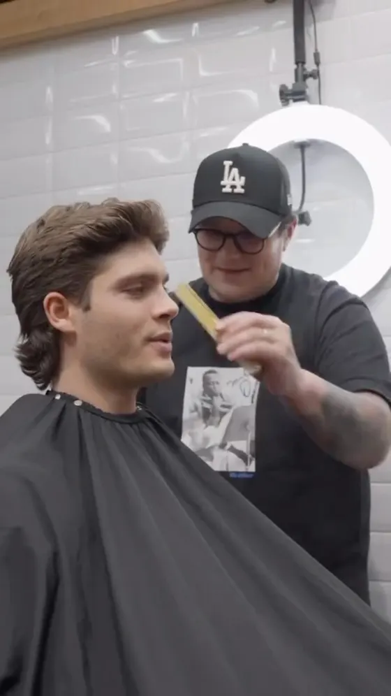 A barber matching a client's reference photo