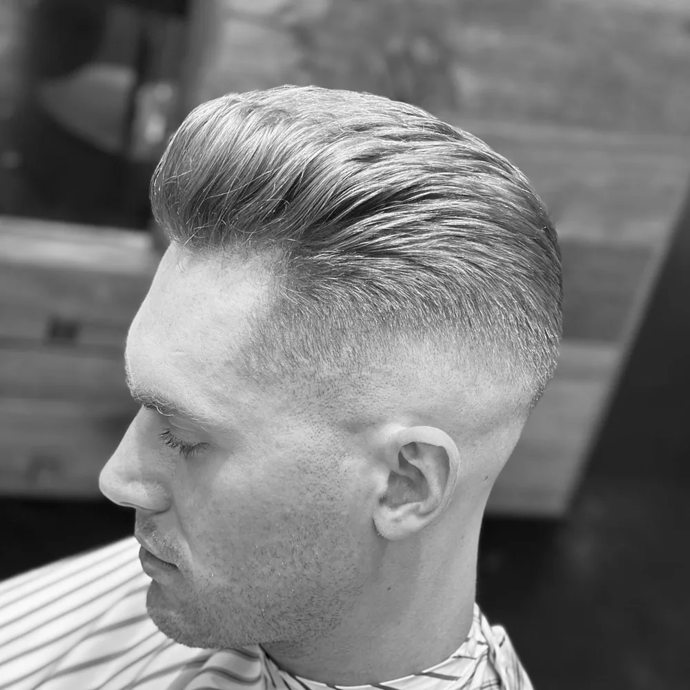 Slicked-back cut with a high disconnected fade