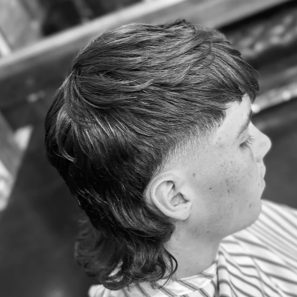 Modern mullet with a clean taper through the sides