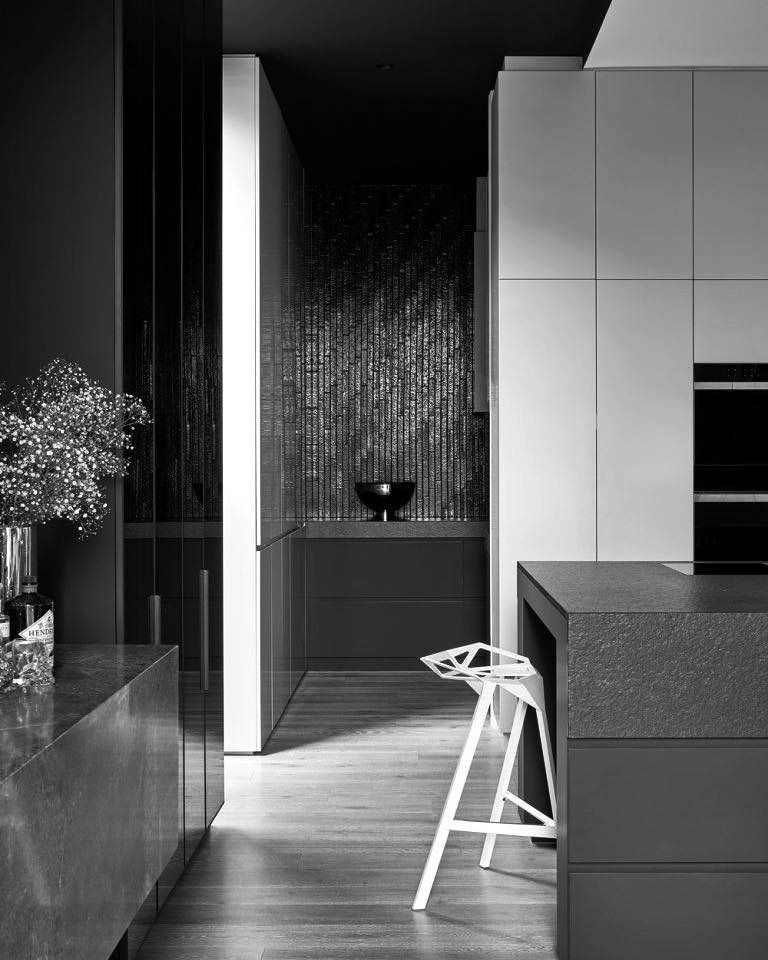 Bespoke kitchen in the Aberfeldie renovation with a waterfall stone island and integrated appliances.